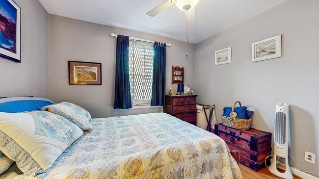 Bedroom featuring wood finished floors and ceiling fan | Image 18