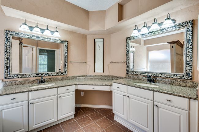 Bathroom featuring two vanities, tile patterned flooring, and a sink | Image 19
