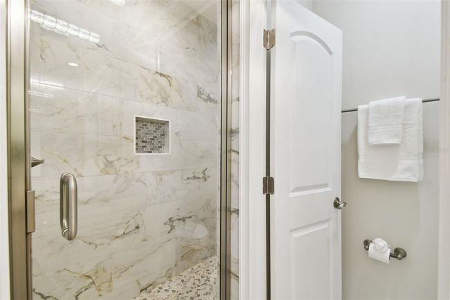 View of lavish tile work in bathrooms. | Image 23
