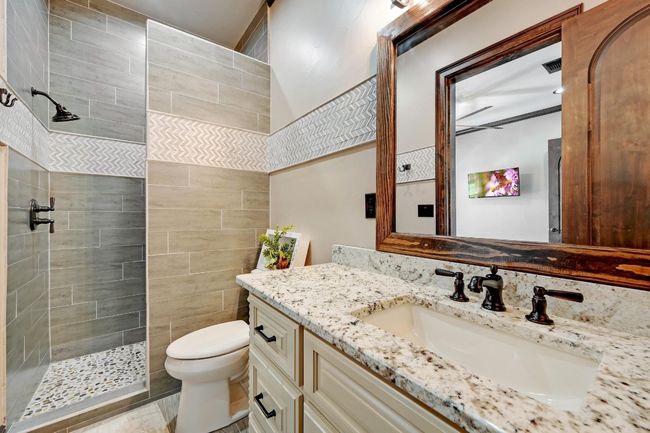 Bathroom with a walk in shower, vanity, visible vents, and toilet | Image 28