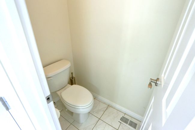 Bathroom featuring visible vents and toilet | Image 15