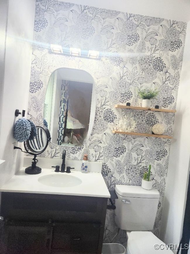Half bath featuring vanity and wallpapered walls | Image 20
