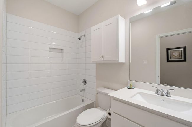 One of the three bathrooms, located near one of the secondary bedrooms and centrally located in the home for family or guest use. | Image 25