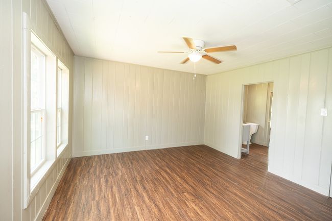 Spare room featuring wood finished floors and a ceiling fan | Image 19