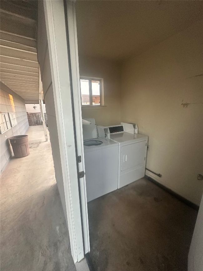 Clothes washing area featuring washing machine and clothes dryer | Image 20