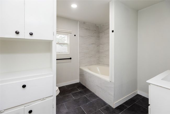 Full bathroom with vanity, baseboards, tile patterned floors, toilet, and recessed lighting | Image 11