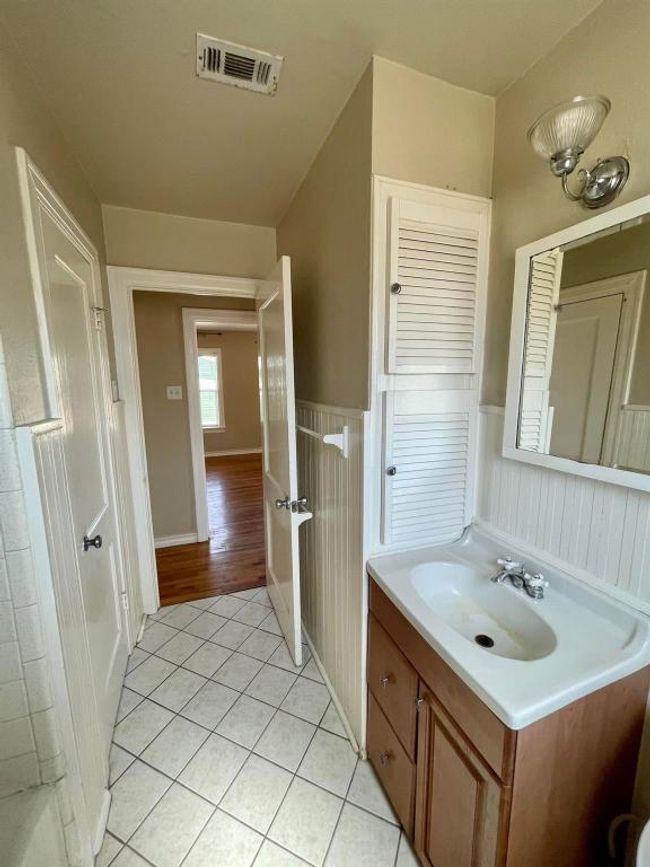 Bathroom with tile patterned floors, a wainscoted wall, and vanity | Image 12