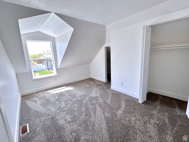 Bonus room featuring baseboards, visible vents, carpet floors, and lofted ceiling | Image 26
