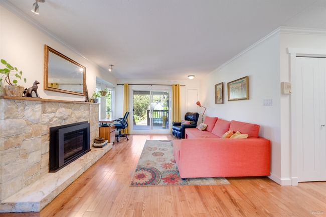 Living area with a fireplace, baseboards, ornamental molding, and wood-type flooring | Image 19
