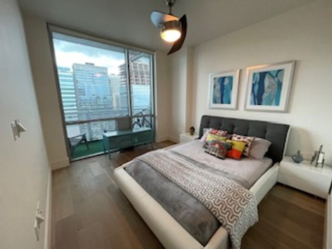 Bedroom with wood finished floors and ceiling fan | Image 4