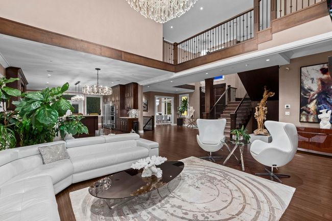 Living room featuring recessed lighting, wood finished floors, stairway, and a chandelier | Image 5