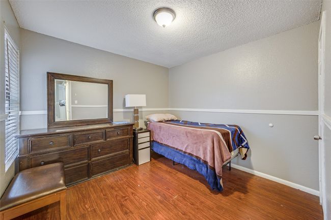 Unit B Bedroom with a textured ceiling and hardwood / wood-style floors | Image 24