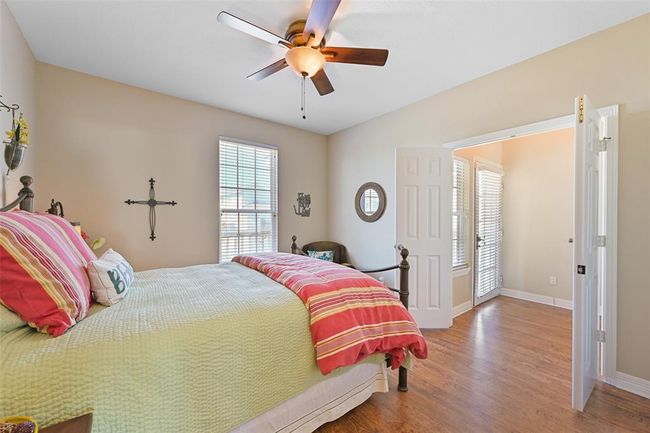 Spacious main-floor bedroom with a queen bed and generous closet. | Image 15