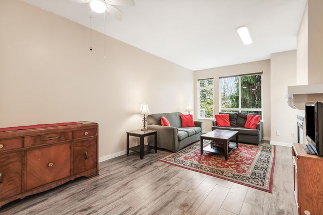 Living room featuring light wood-style floors, ceiling fan, and baseboards | Image 7