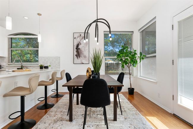 Dining space with wood finished floors and baseboards | Image 8