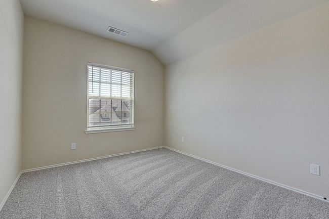 Unfurnished room featuring carpet floors, baseboards, and lofted ceiling | Image 17