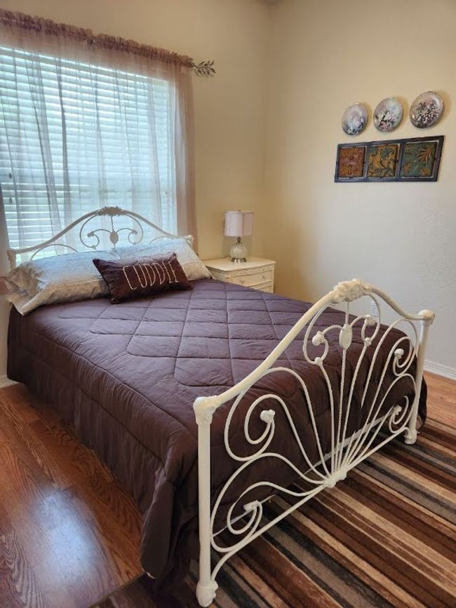 Bedroom with baseboards and wood finished floors | Image 15