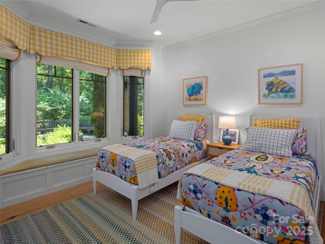 Terrace level guest suite has a built-in window seat, walk-in closet with custom built-ins. Not shown is the adjoinging bathroom. | Image 33