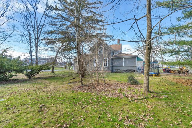 View of grassy yard with a sunroom | Image 49