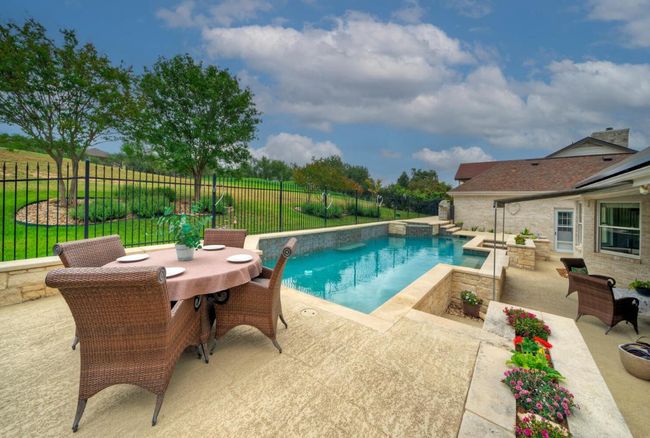 View of swimming pool featuring a patio, a fenced backyard, outdoor dining area, and a fenced in pool | Image 35