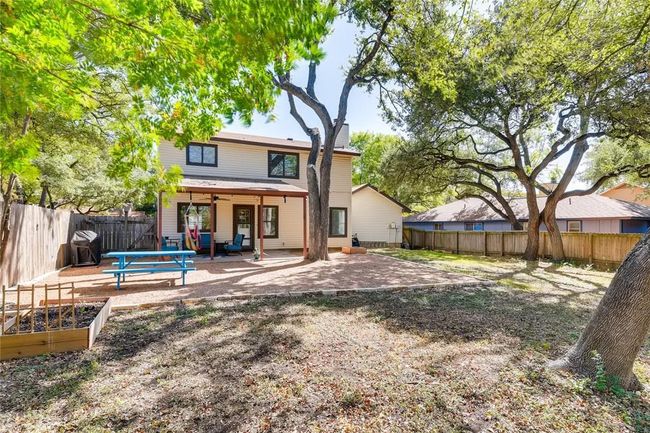 Rear view of property with a garden, a patio area, and a fenced backyard | Image 27