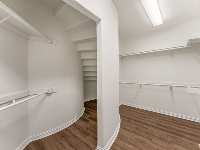 Spacious closet with wood finished floors | Image 19