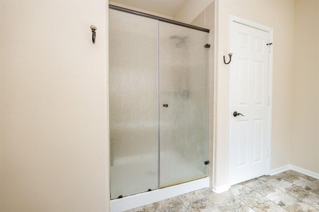 Your primary walk-in shower makes for a comfortable, practical use of space! | Image 27