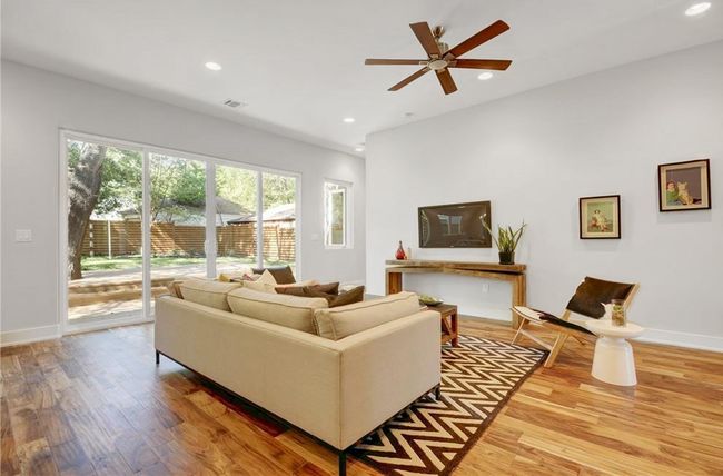 Living area with visible vents, wood finished floors, baseboards, ceiling fan, and recessed lighting | Image 6