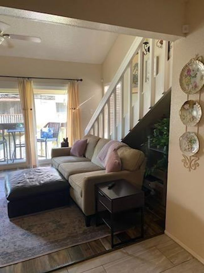 Glass wall along balcony and stairs to lofted bedroom and full bathroom upstairs. | Image 7
