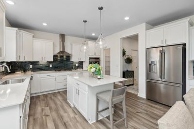 (Photo of decorated model, finishes will vary) The kitchen has ease-of-access to the mudroom and flows seamlessly into the dining room | Image 3