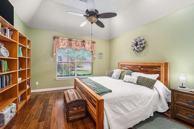 Secondary bedroom off the entry with views of the front yard. | Image 8