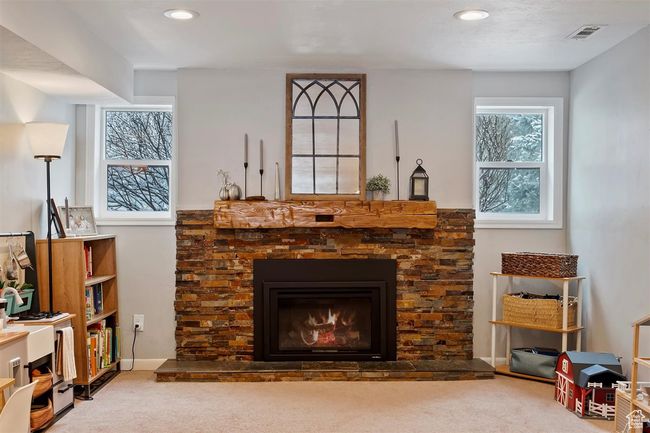 Carpeted living room featuring a fireplace, recessed lighting, and baseboards | Image 19