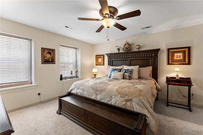 Carpeted bedroom featuring visible vents, baseboards, and ceiling fan | Image 29