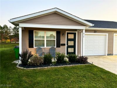 Single story home with a front lawn and a garage | Image 1