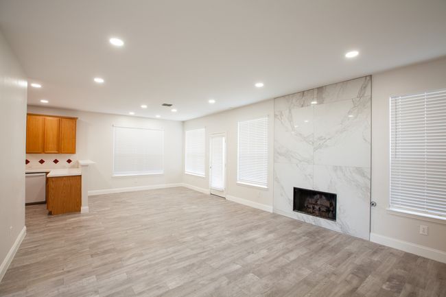 Unfurnished living room with recessed lighting, light wood-style floors, and a fireplace | Image 20