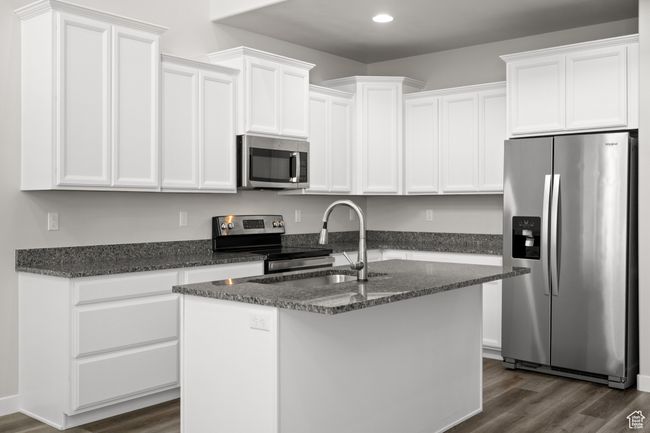 Kitchen with stainless steel appliances, white cabinets, and recessed lighting | Image 10