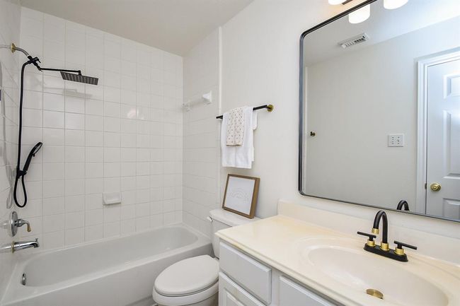 Your third secondary bathroom measures 5' x 9' and is complete with framed mirror, spacious vanity with plenty of counter space for routines and ample cabinet space for toiletries and towels, as well as a shower/tub combo. | Image 34