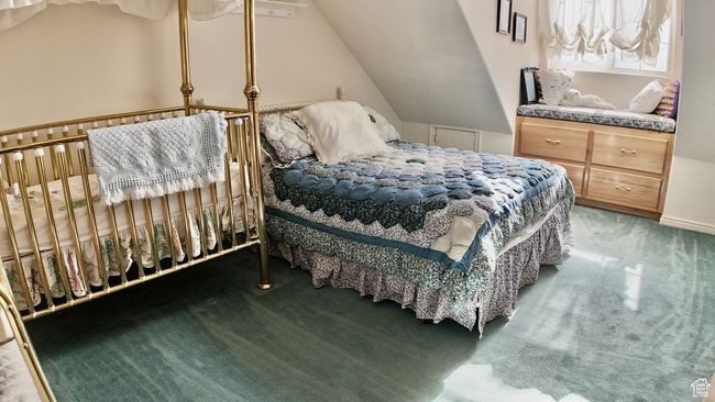 Carpeted bedroom with lofted ceiling | Image 62