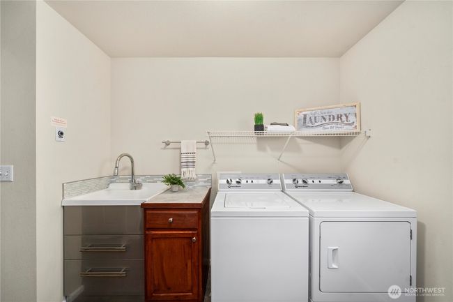 upstairs laundry rm is massive & includes a sink. | Image 29