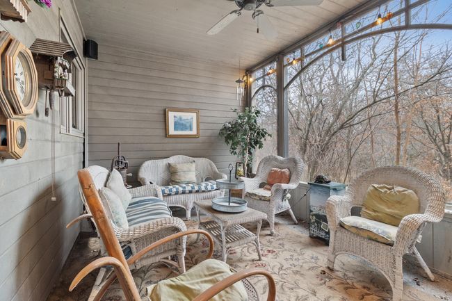Screened in porch with entry door to main hallway and screen door to garage and driveway area. Speakers part of whole house audio. | Image 18