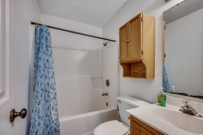 Full bath featuring shower / bathtub combination with curtain and vanity | Image 30