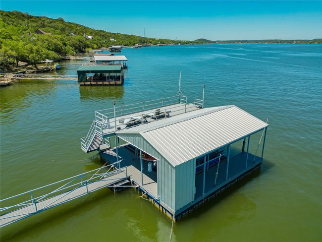 View of dock featuring boat lift and a water view | Image 10