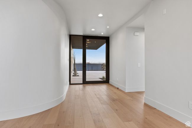Unfurnished room featuring recessed lighting, baseboards, light wood-style floors, and a wall of windows | Image 18