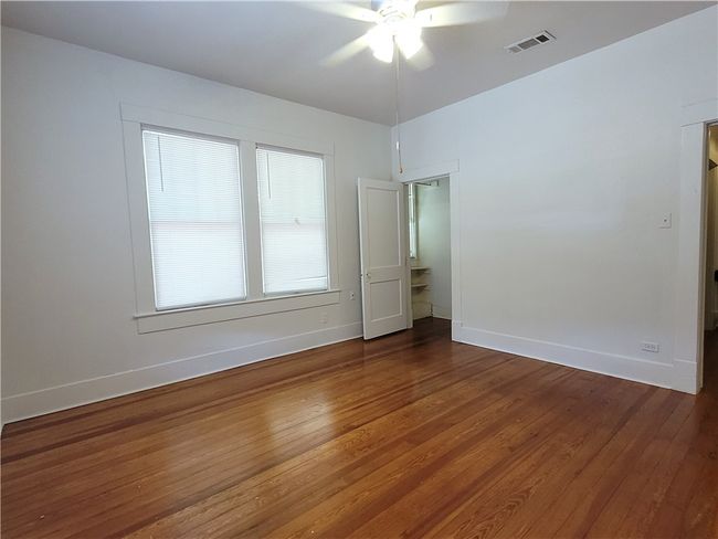 Bedrooms feature hardwood floor and natural light | Image 11