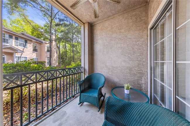 Screend in patio with sliding doors into the kitchen and the owner's suite | Image 31
