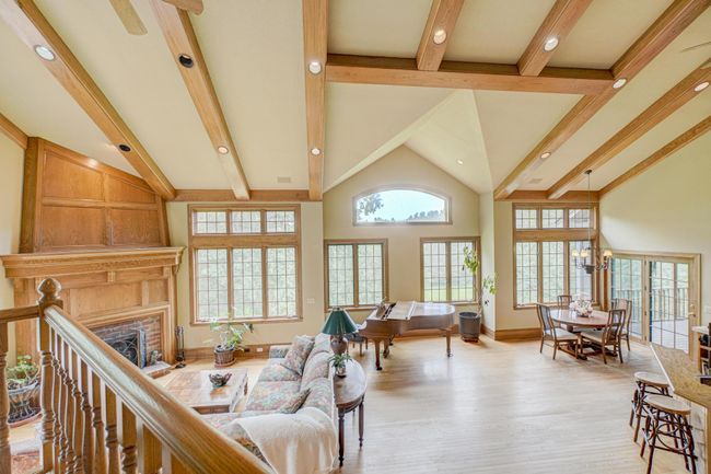 Step inside to be greeted by soaring 18-foot vaulted, beamed ceilings, walls of windows, and exquisite custom millwork that show craftsmanship in every corner | Image 6