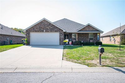 View of front of house with central AC unit, a garage, and a front lawn | Image 2