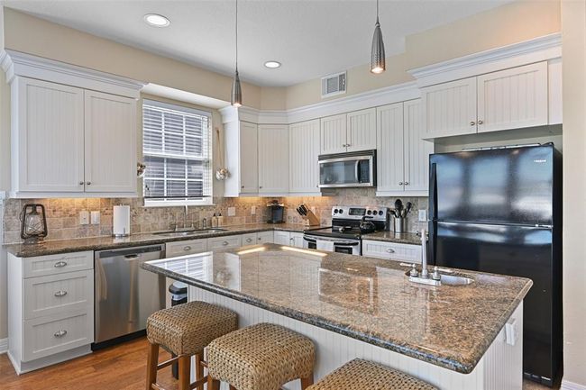 Expansive bead board cabinets with a fresh coat of paint. | Image 10