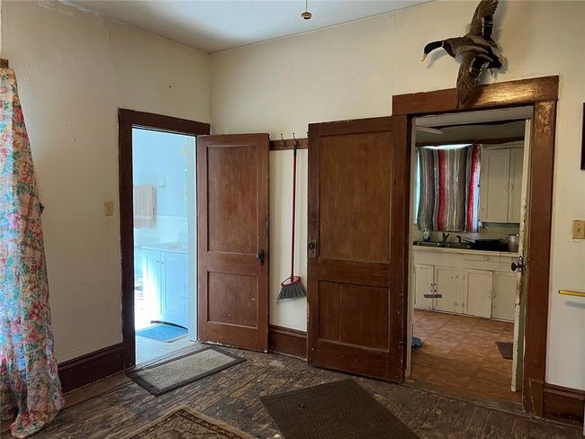 Unfurnished bedroom with sink, hardwood / wood-style floors, and connected bathroom | Image 20