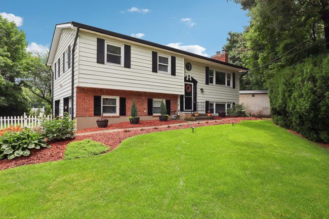 Raised ranch with a chimney, asphalt driveway, brick siding, and an attached garage | Image 37